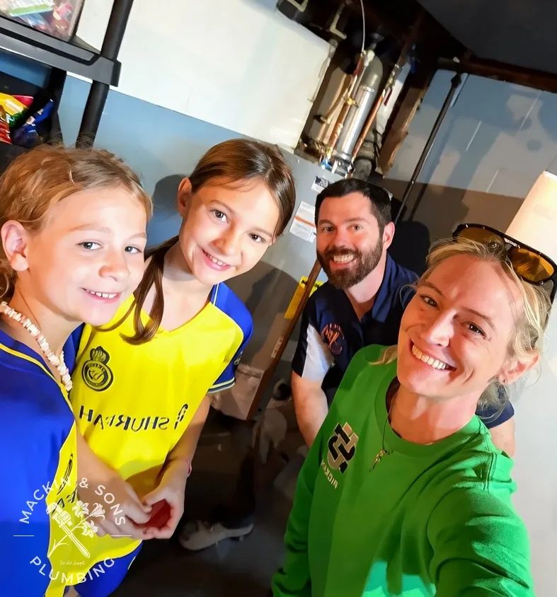 Jessica's family selfie with Thomas, a Mackin & Sons plumber, in their Wadsworth basement after the new water heater install