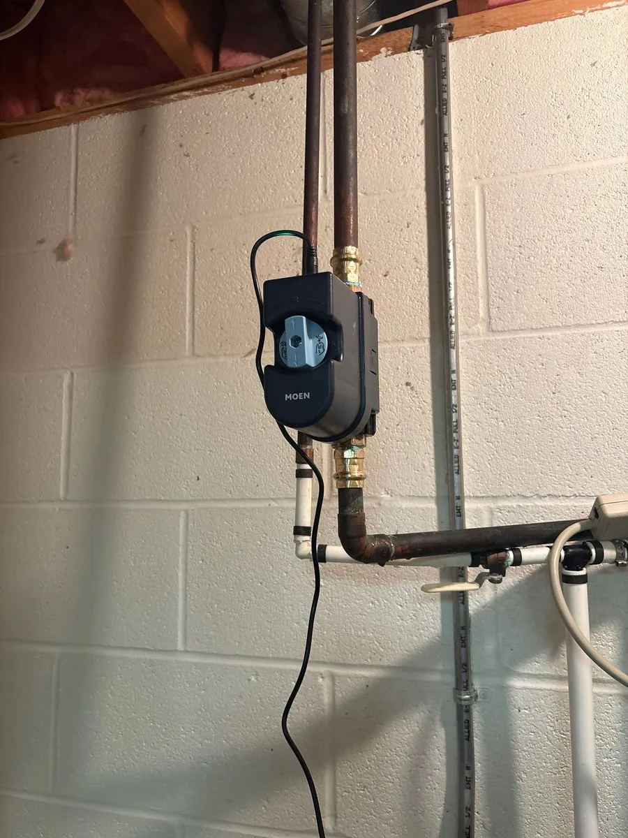 Moen Flo Smart Water Monitor and Shutoff installed on a copper main water line in a Wadsworth basement