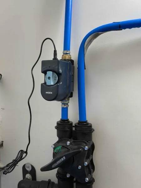 Moen Flo shutoff installed on a blue PEX main water line in a Doylestown utility room