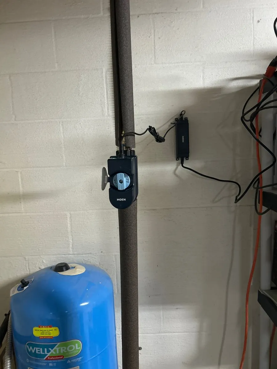 Moen Flo shutoff installed on the main line above a well pressure tank in a Wadsworth basement