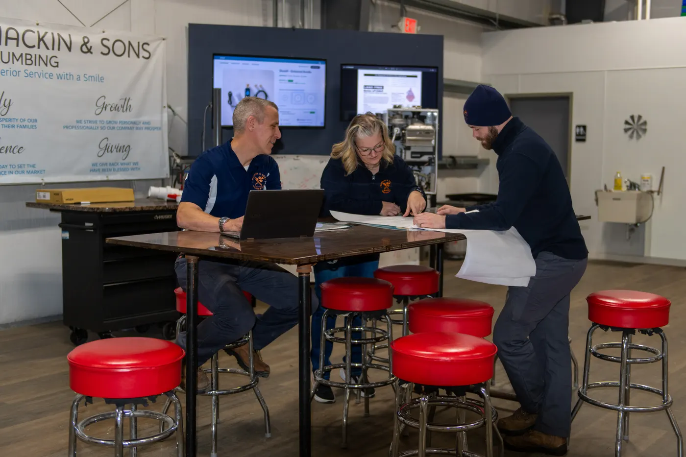 The Mackin & Sons crew reviewing job plans at the shop